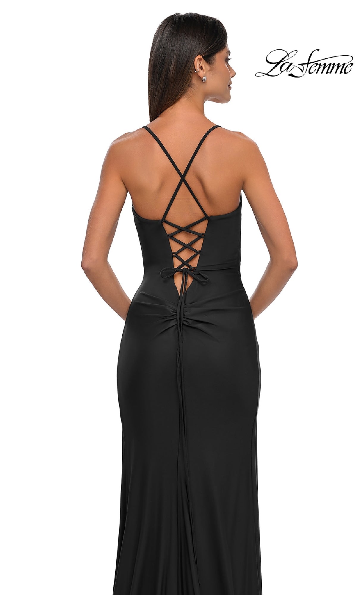 A woman is seen from behind wearing the Lace-Up Simple Long Prom Dress: La Femme 33103, featuring crisscross straps and a lace-up back.